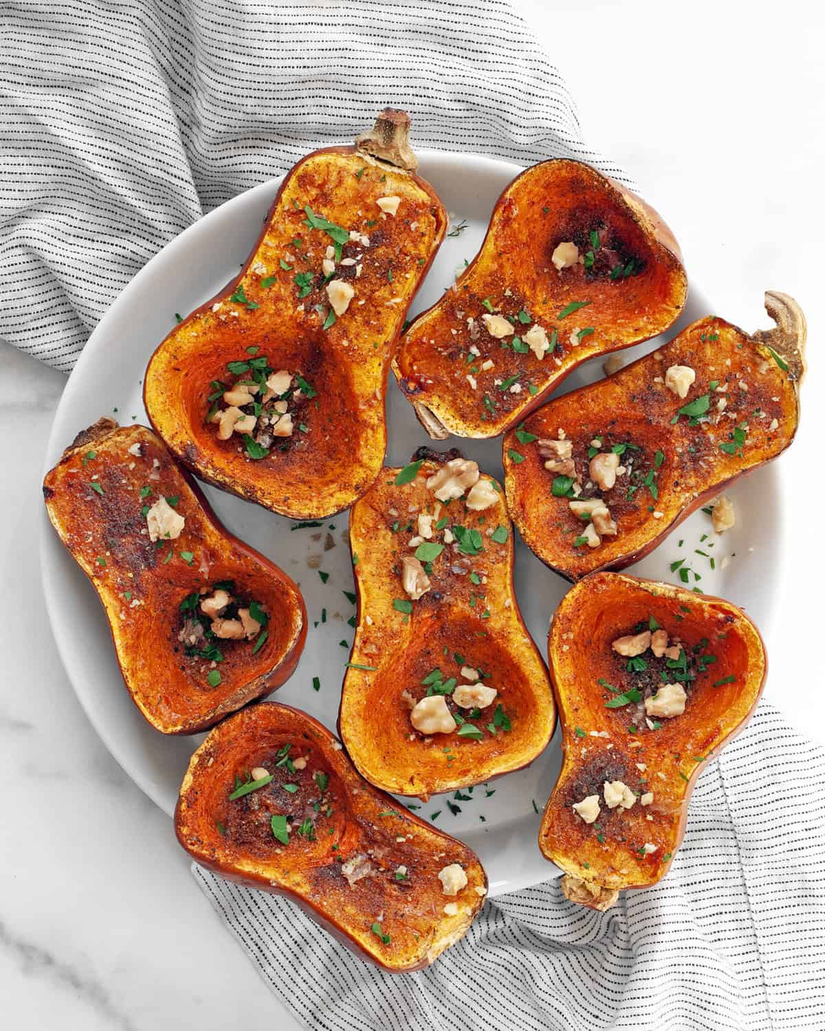 Moroccan-spiced roasted honeynut squash on a plate.