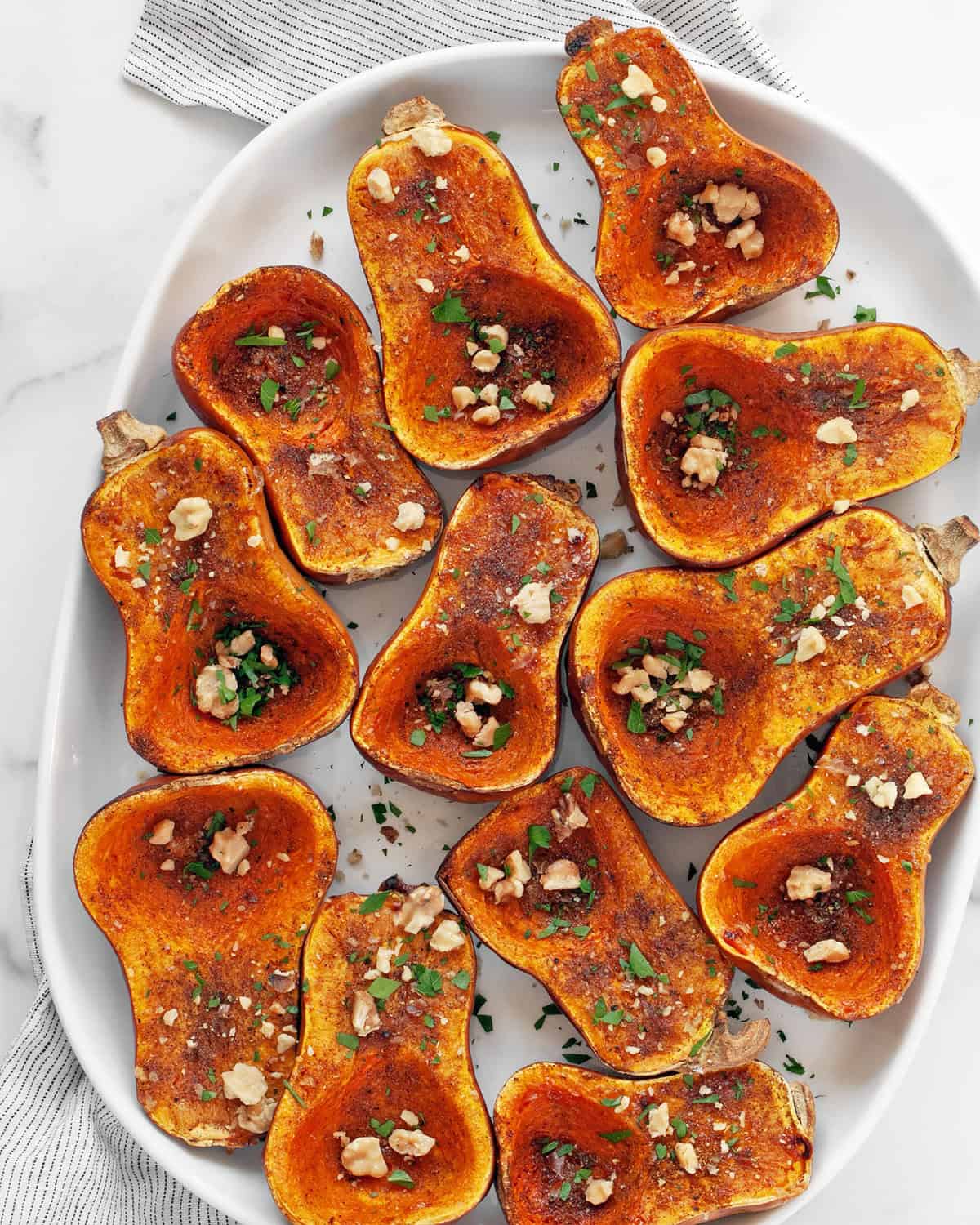 Moroccan-spiced honeynut squash on a serving platter.