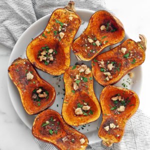 Moroccan-spiced roasted honeynut squash on a plate.