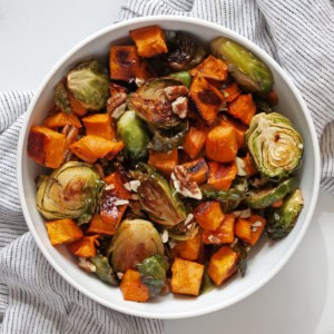 Roasted brussels sprouts and sweet potatoes on a plate.