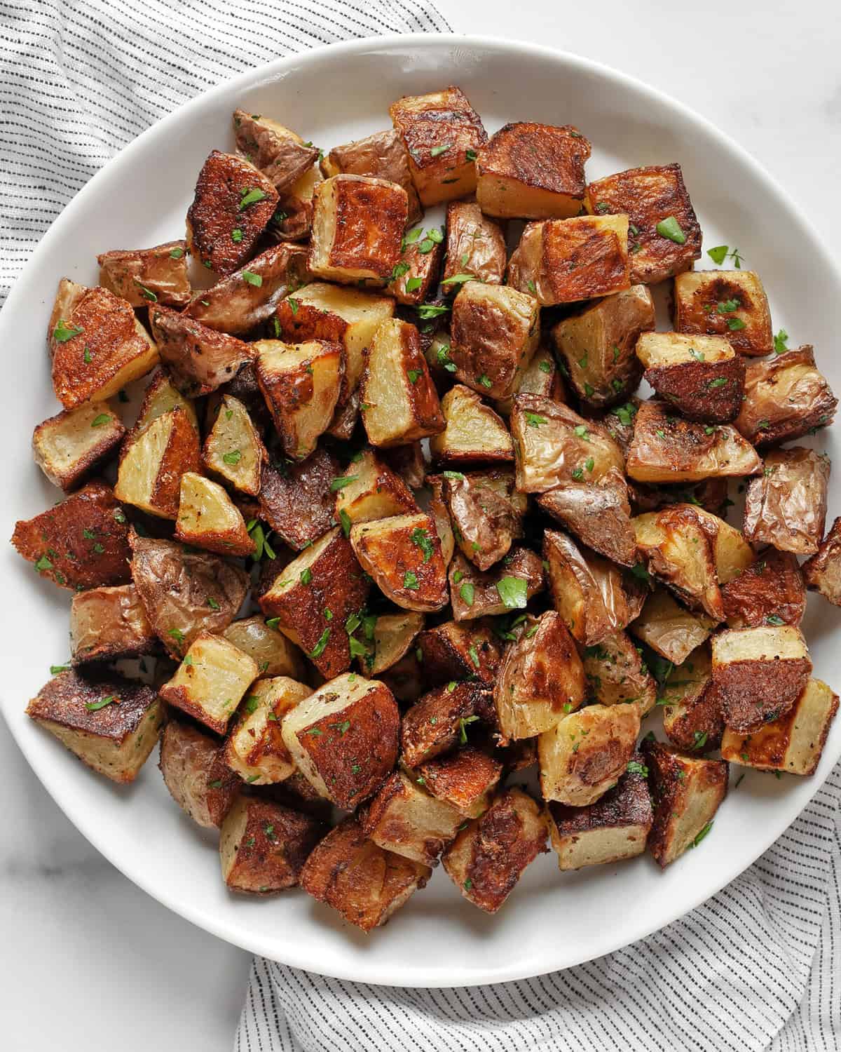 Roasted yukon gold potatoes on a plate.