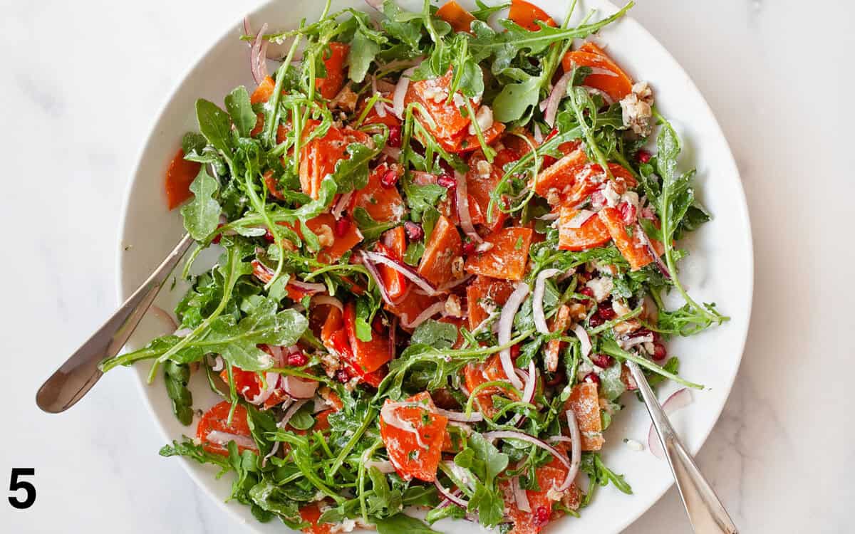 Salt tossed with greens in a bowl.