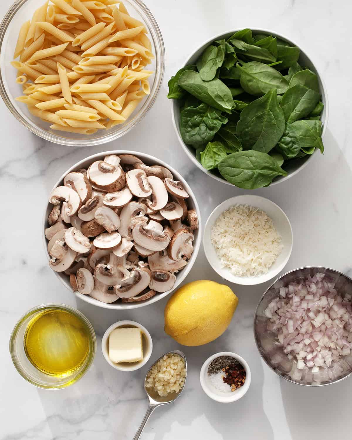 Ingredients including mushrooms, spinach, penne, lemon, garlic, olive oil, Parmesan, shallots, butter, and seasonings.