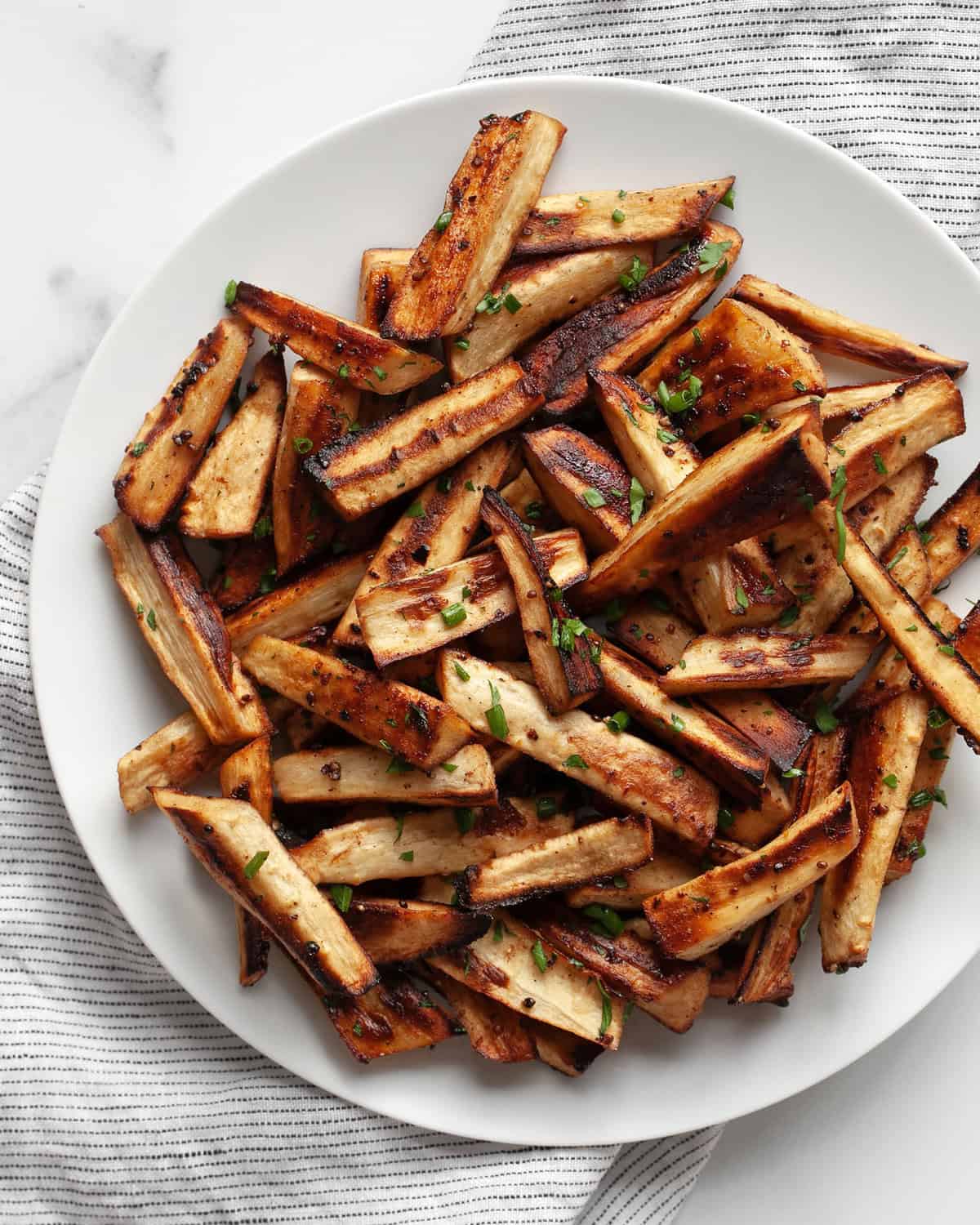 Roasted parsnips on a plate.