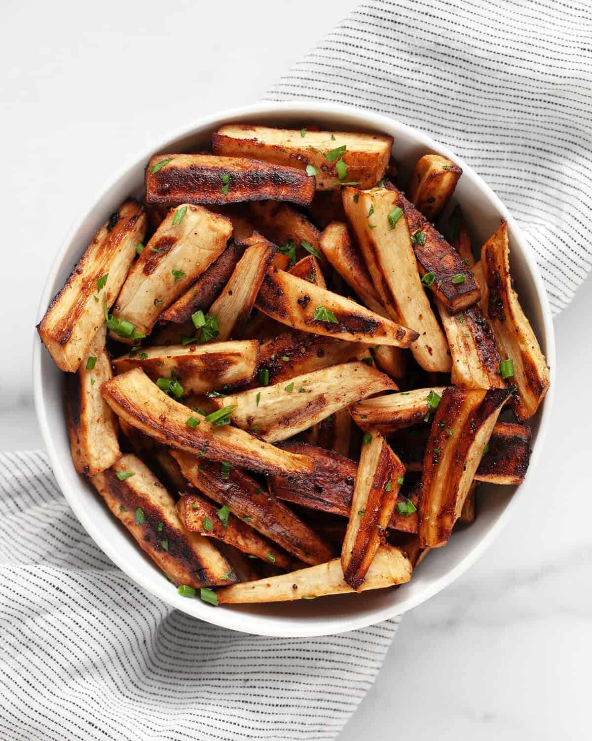 Maple balsamic roasted parsnips in a bowl.