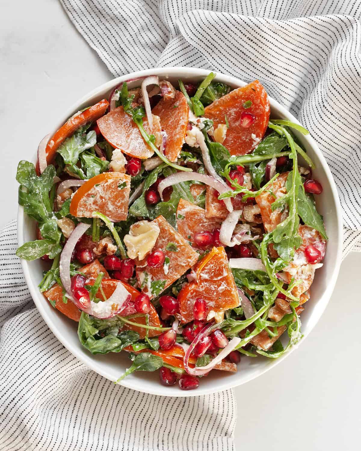 Persimmon salad in a bowl.