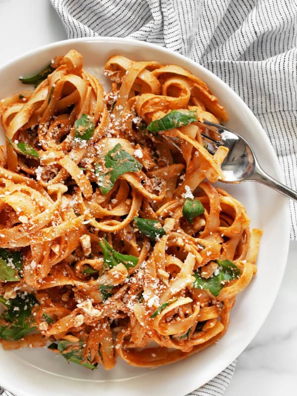 Creamy sun dried tomato pasta on a plate.