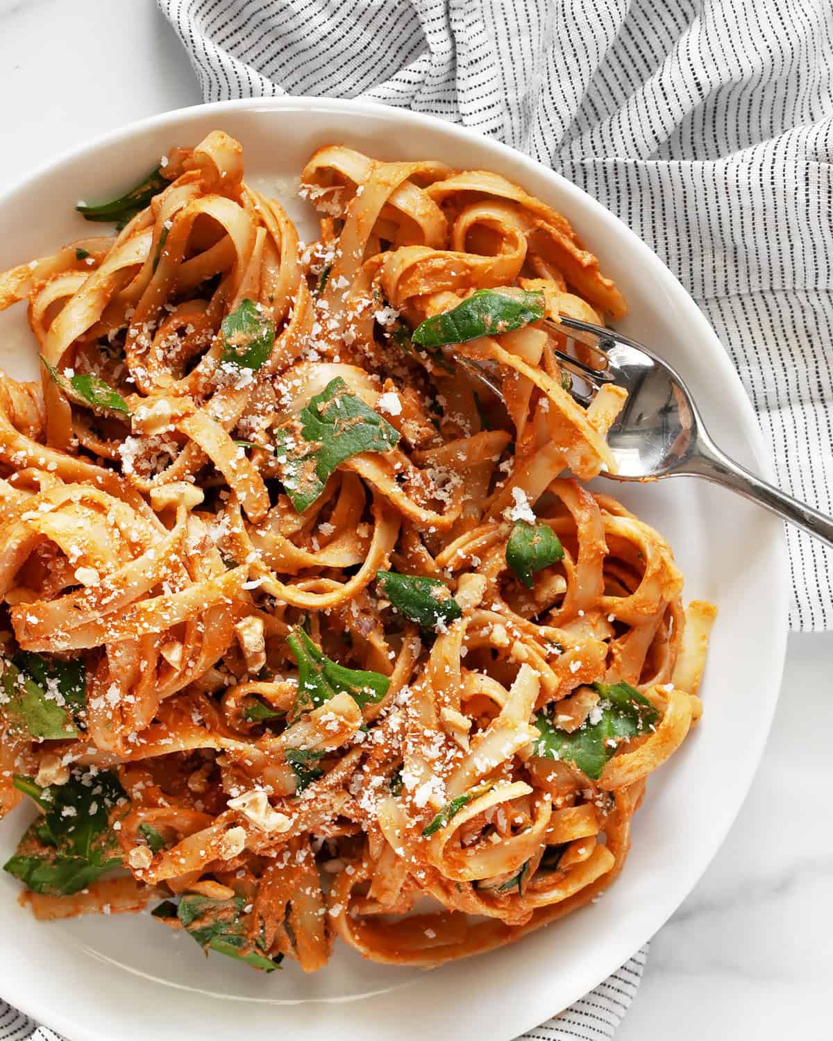 Creamy sun dried tomato pasta on a plate.