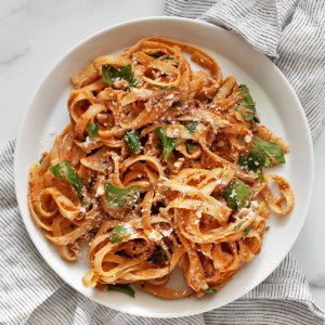 Creamy sun dried tomato pasta on a plate.