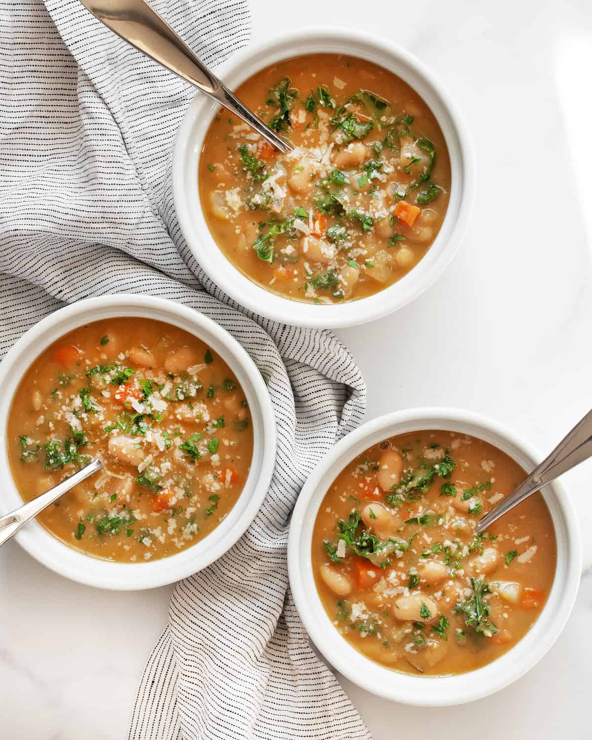 Three bowls of Italian white bean soup.