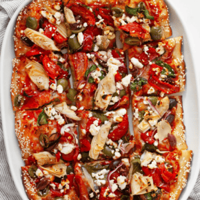 Pizza cut into squares on a serving plate.