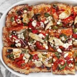 Pizza cut into squares on a serving plate.