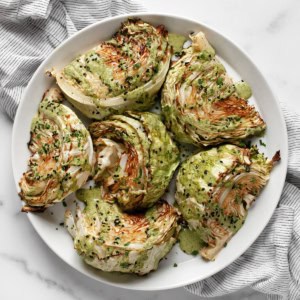 Roasted cabbage wedges on a plate.