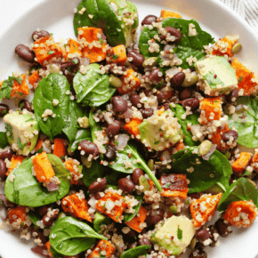 Roasted sweet potato salad with black beans, quinoa and spinach on a plate.