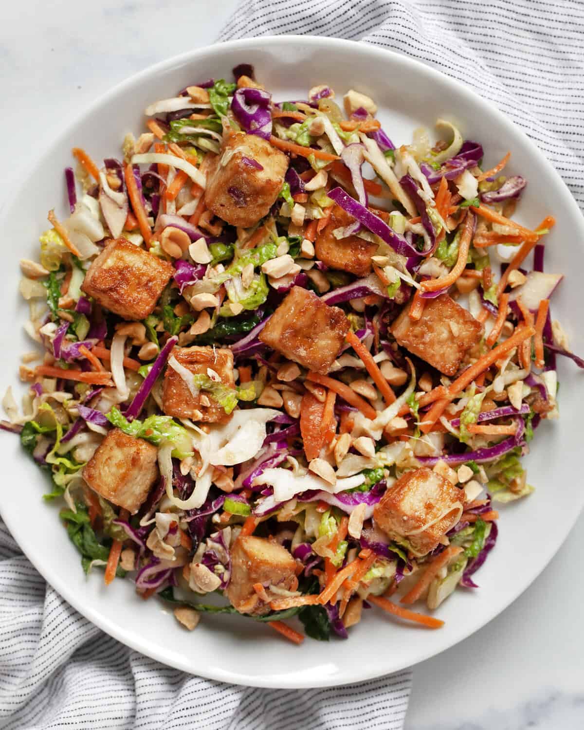 Crispy baked tofu salad on a plate.