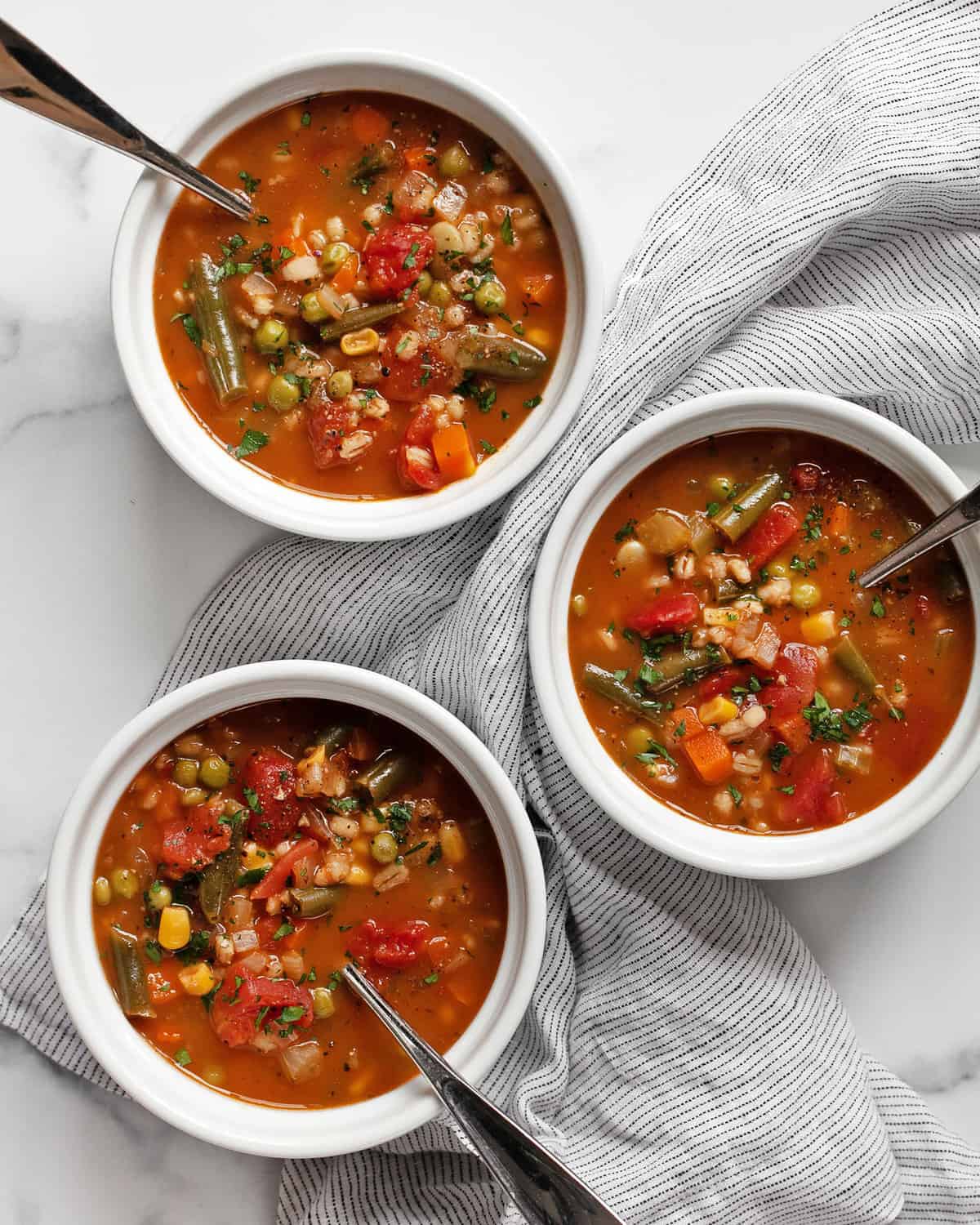 Three bowls of veggie barley soup.