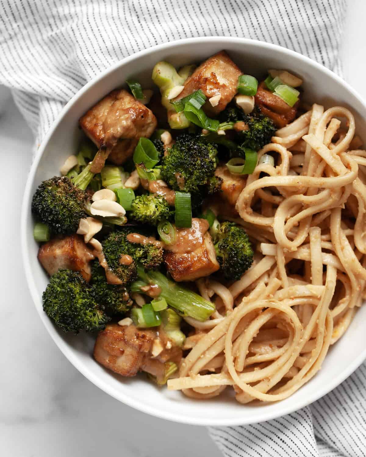 Roasted broccoli tofu bowl with peanut noodles.