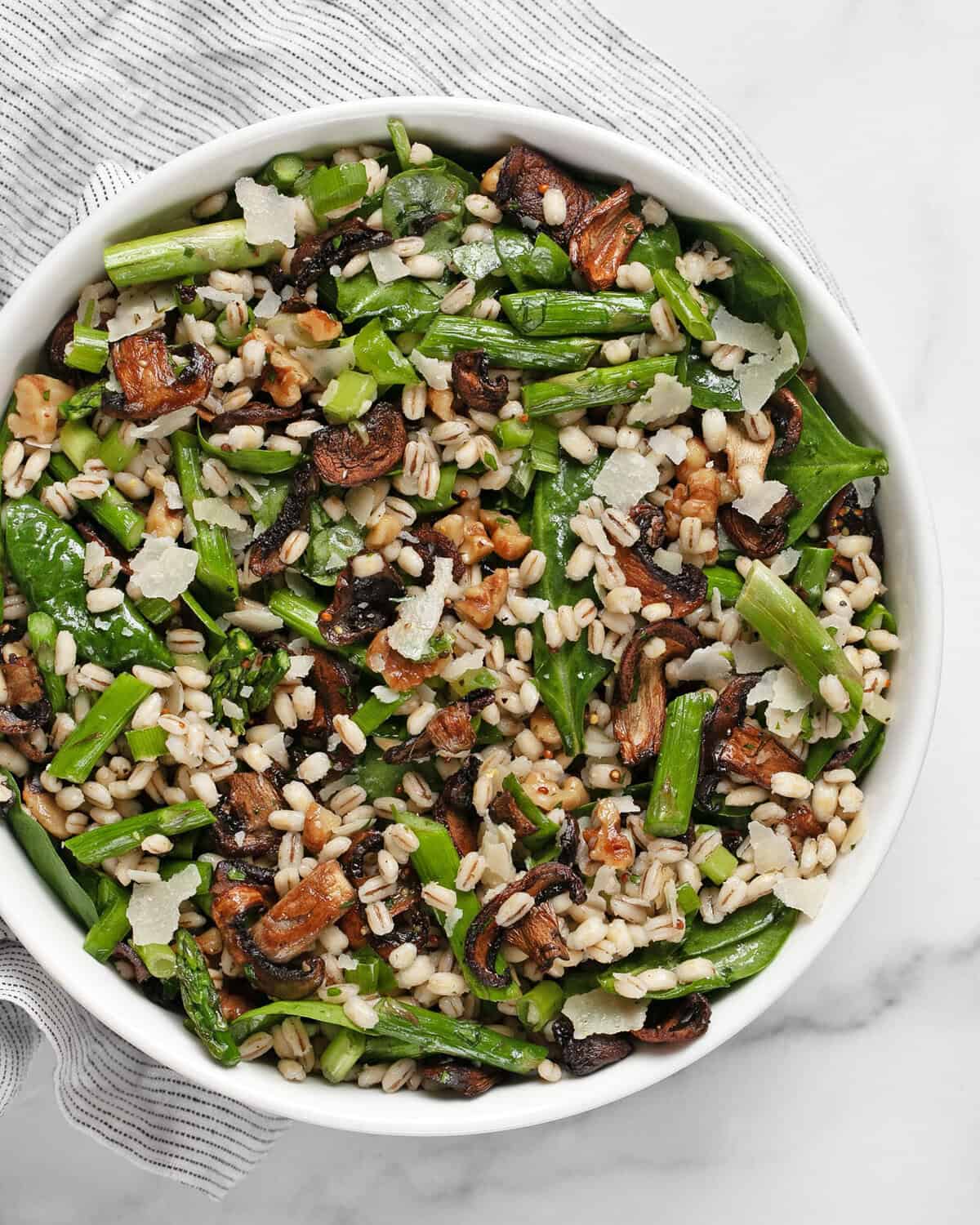 Roasted asparagus mushroom barley salad in a bowl.