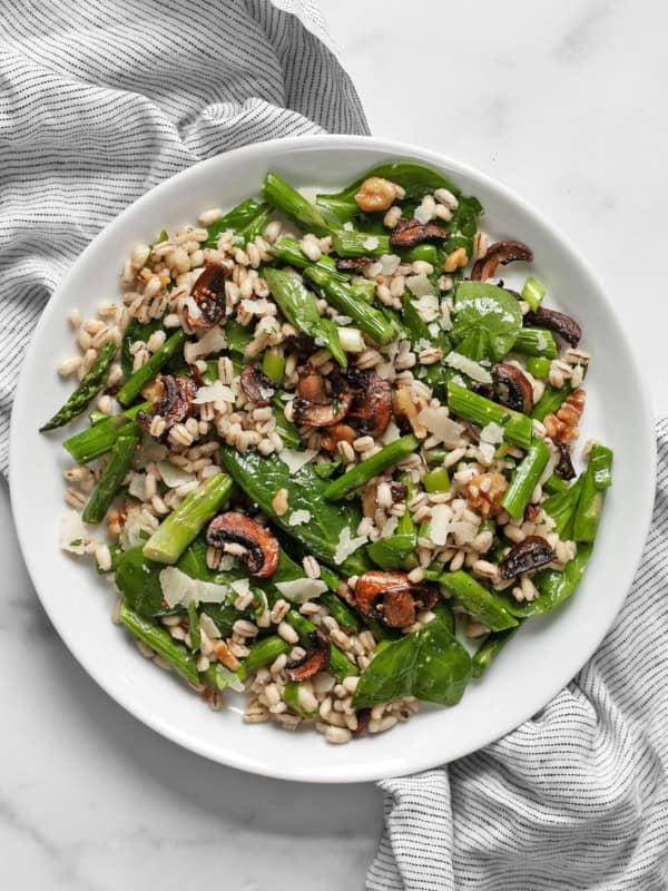 Roasted asparagus mushroom barley salad on a plate.