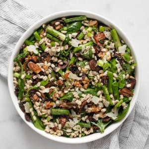 Barley salad with roasted asparagus and mushrooms in a bowl.