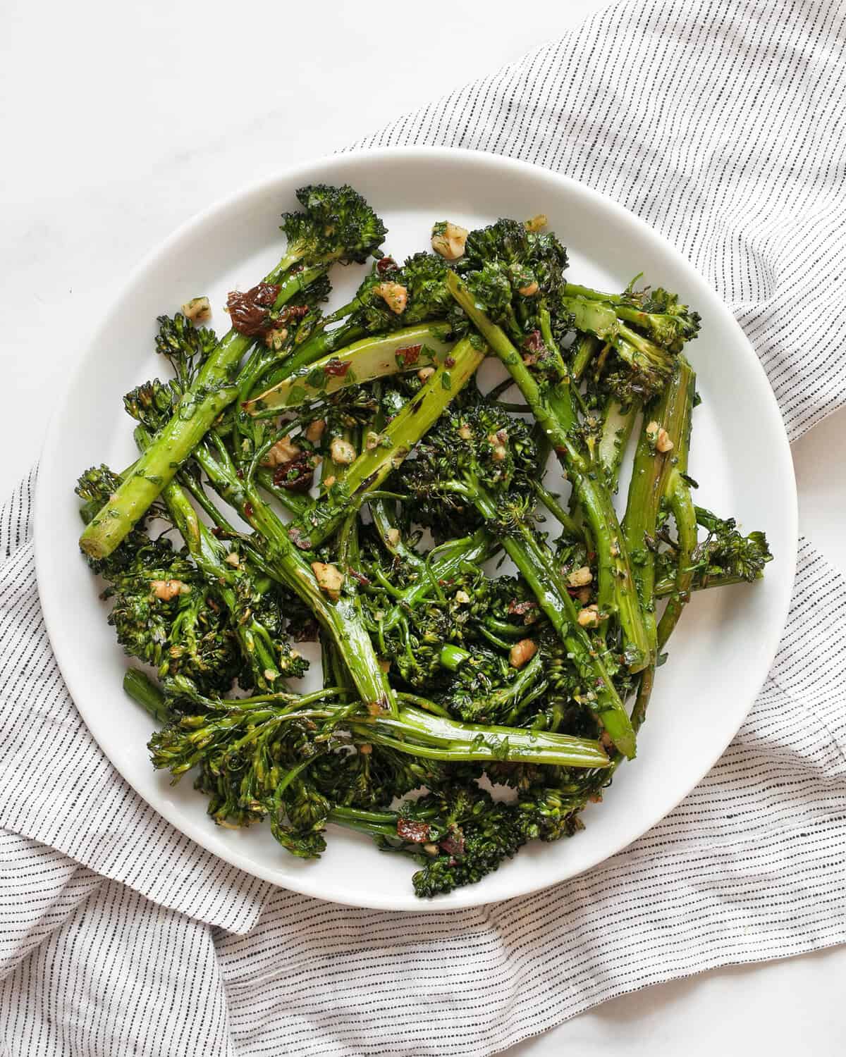 Roasted broccolini on a plate.